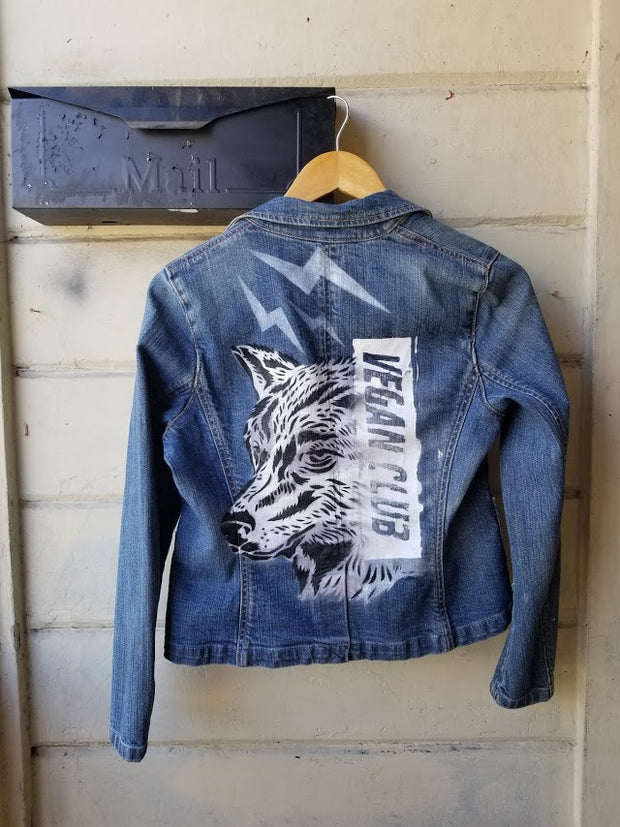 SOLD - Upcycled Jean Jacket Vegan Club featuring a wolf (anti-fur message) hand painted by @praxis_vgz