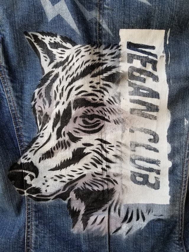 SOLD - Upcycled Jean Jacket Vegan Club featuring a wolf (anti-fur message) hand painted by @praxis_vgz